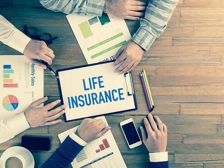 People around a desk discussing life insurance